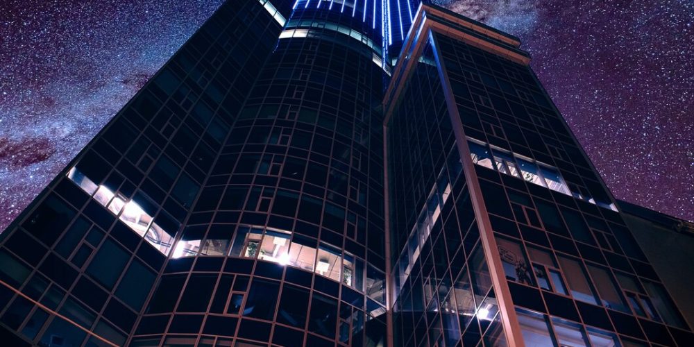 low-angle-shot-modern-futuristic-business-architecture-breathtaking-starry-sky_181624-20935